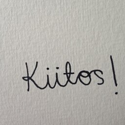 The word 'Kiitos!' written in cursive script