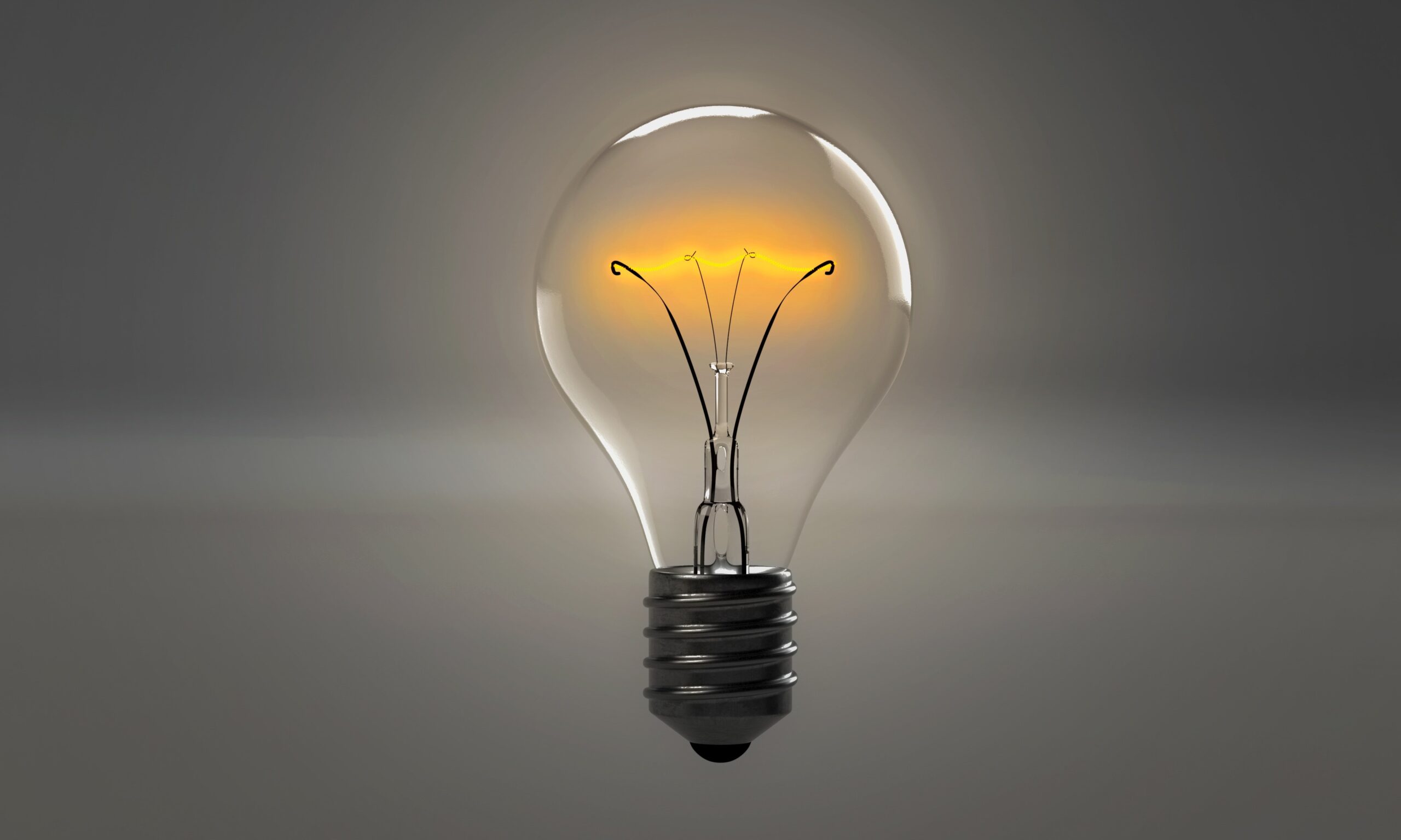 An image of a lightbulb on a grey background.